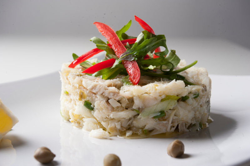 Plated steamed fish salad named Salatouri. Traditional Paros island starter.